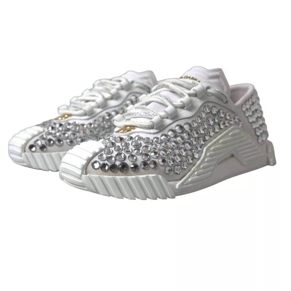 White sneakers with embellishments, featuring a canvas and leather design