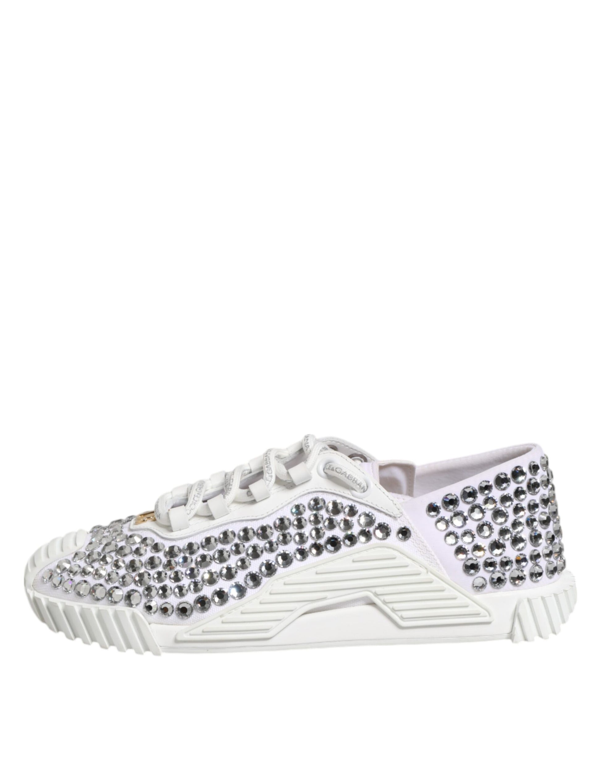 Pair of white sneakers with embellishments and a canvas upper