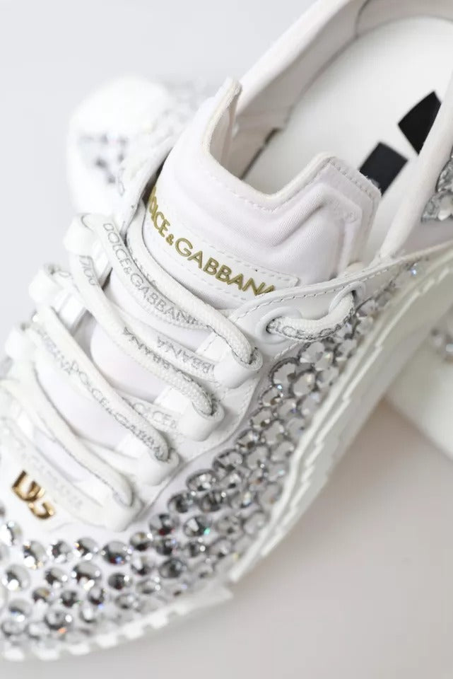 White sneakers with gold embellishments and a canvas upper, featuring the Dolce & Gabbana logo
