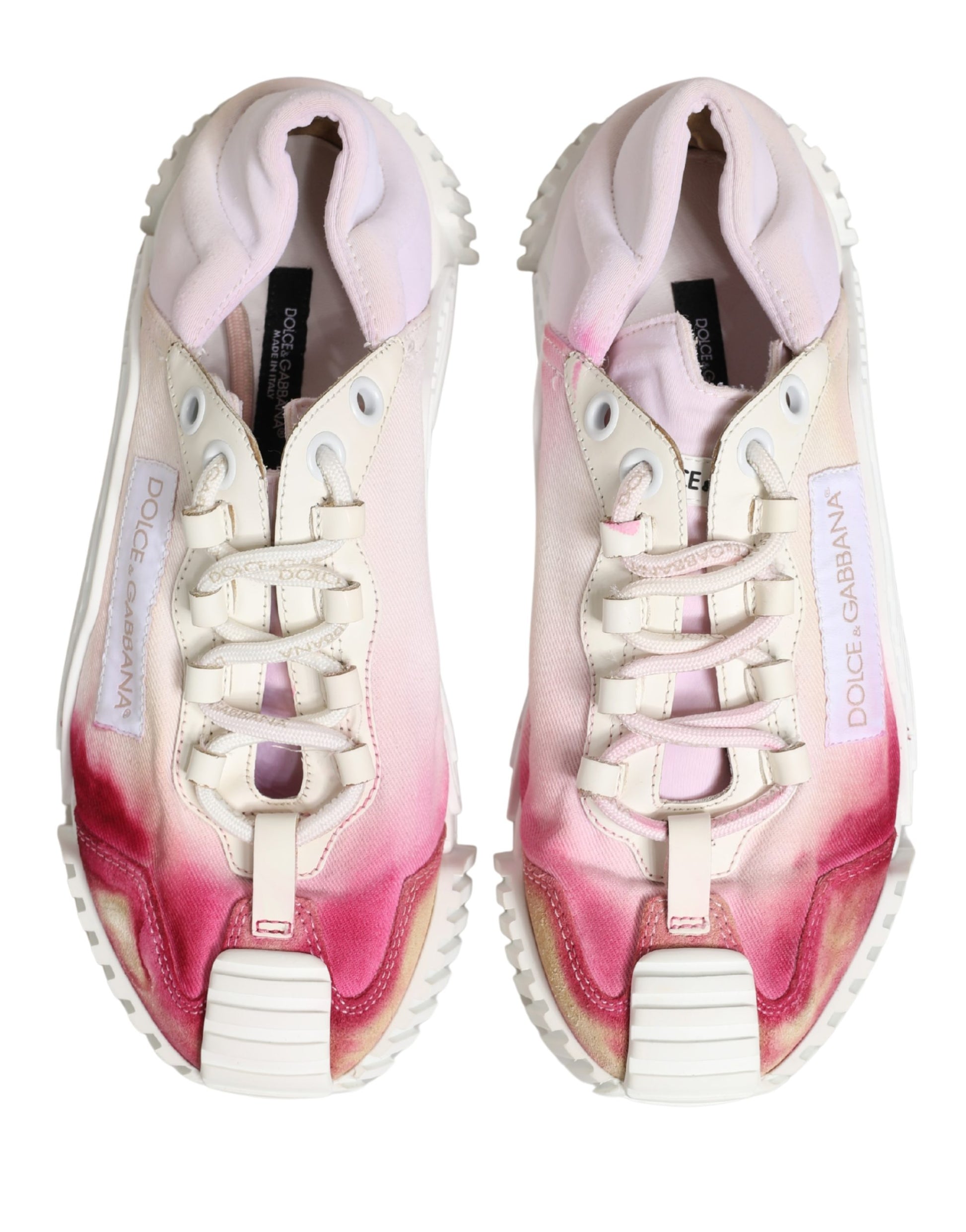 Pair of lace-up sneakers with white base and pink accents
