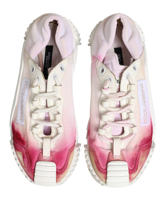 Pair of lace-up sneakers with white base and pink accents
