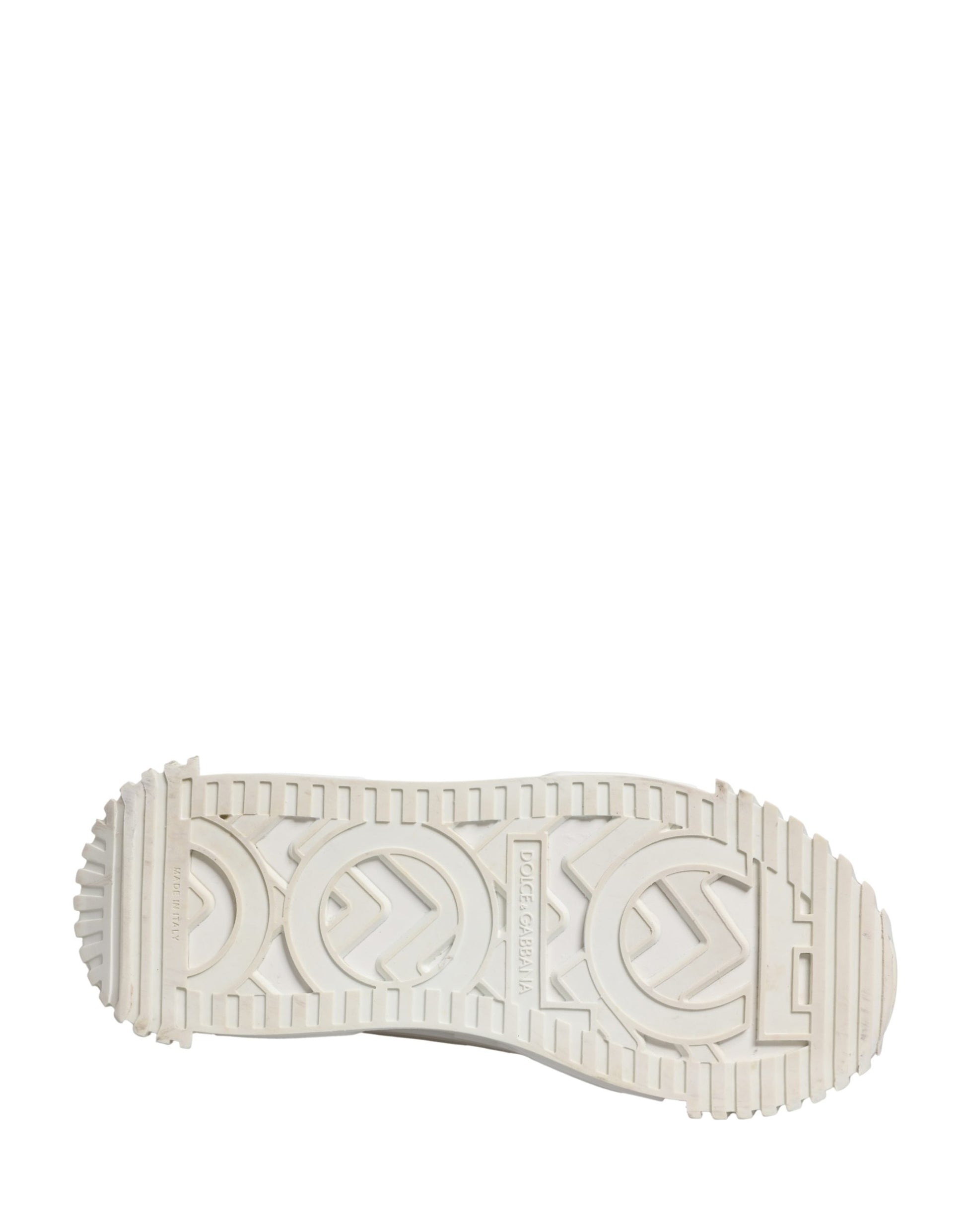 A single white shoe with a lace-up design, featuring the Dolce & Gabbana logo on the side