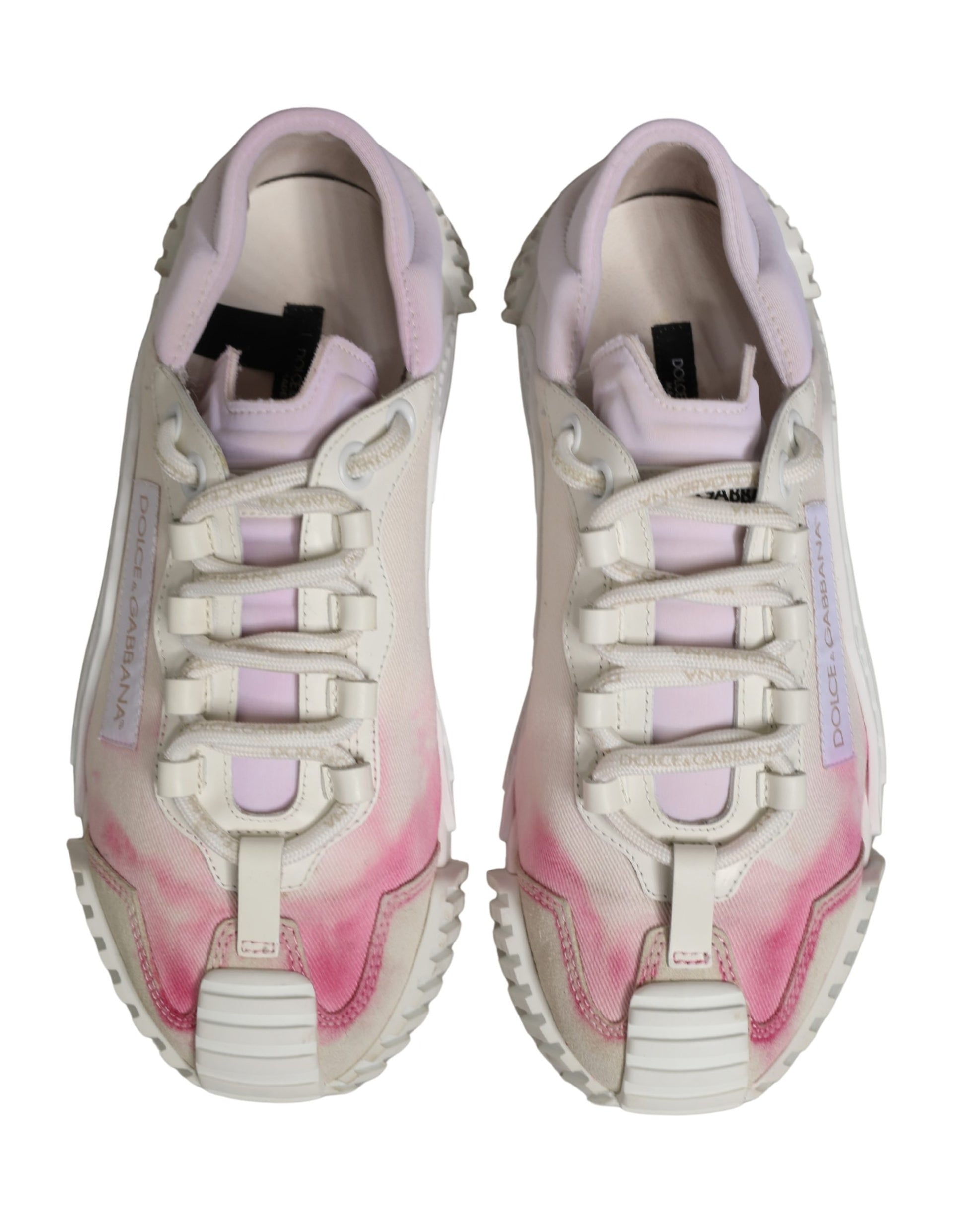 Pair of white lace-up sneakers with pink accents and a logo on the side