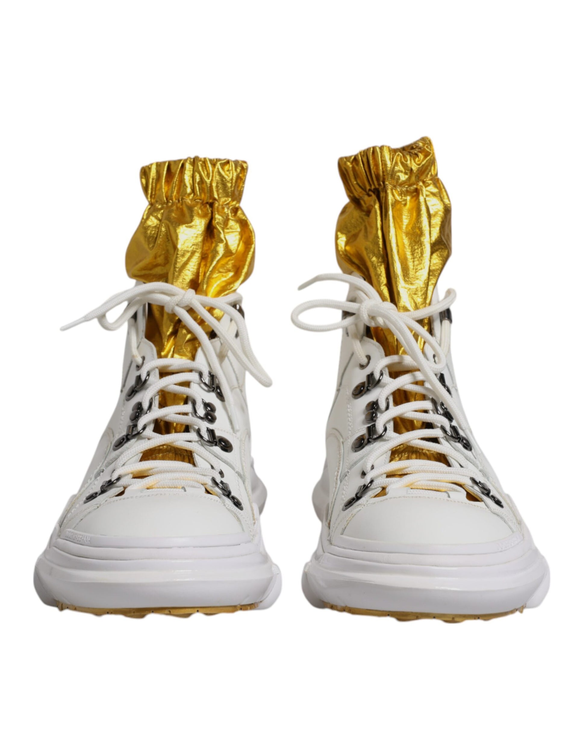 A pair of white nylon shoes with gold accents and a high top design