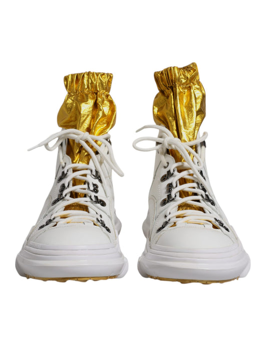 A pair of white nylon shoes with gold accents and a high top design