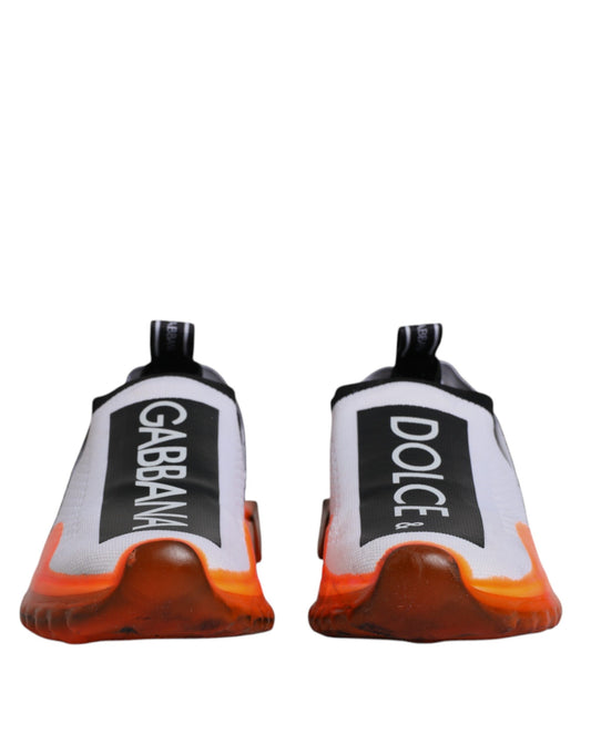 Pair of white and orange slip-on shoes with black text on the side