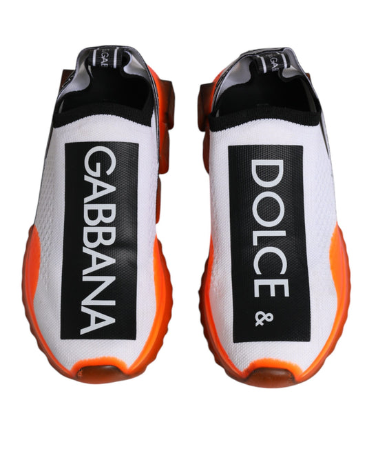 Pair of white, orange, and black slip-on shoes with Dolce & Gabbana branding