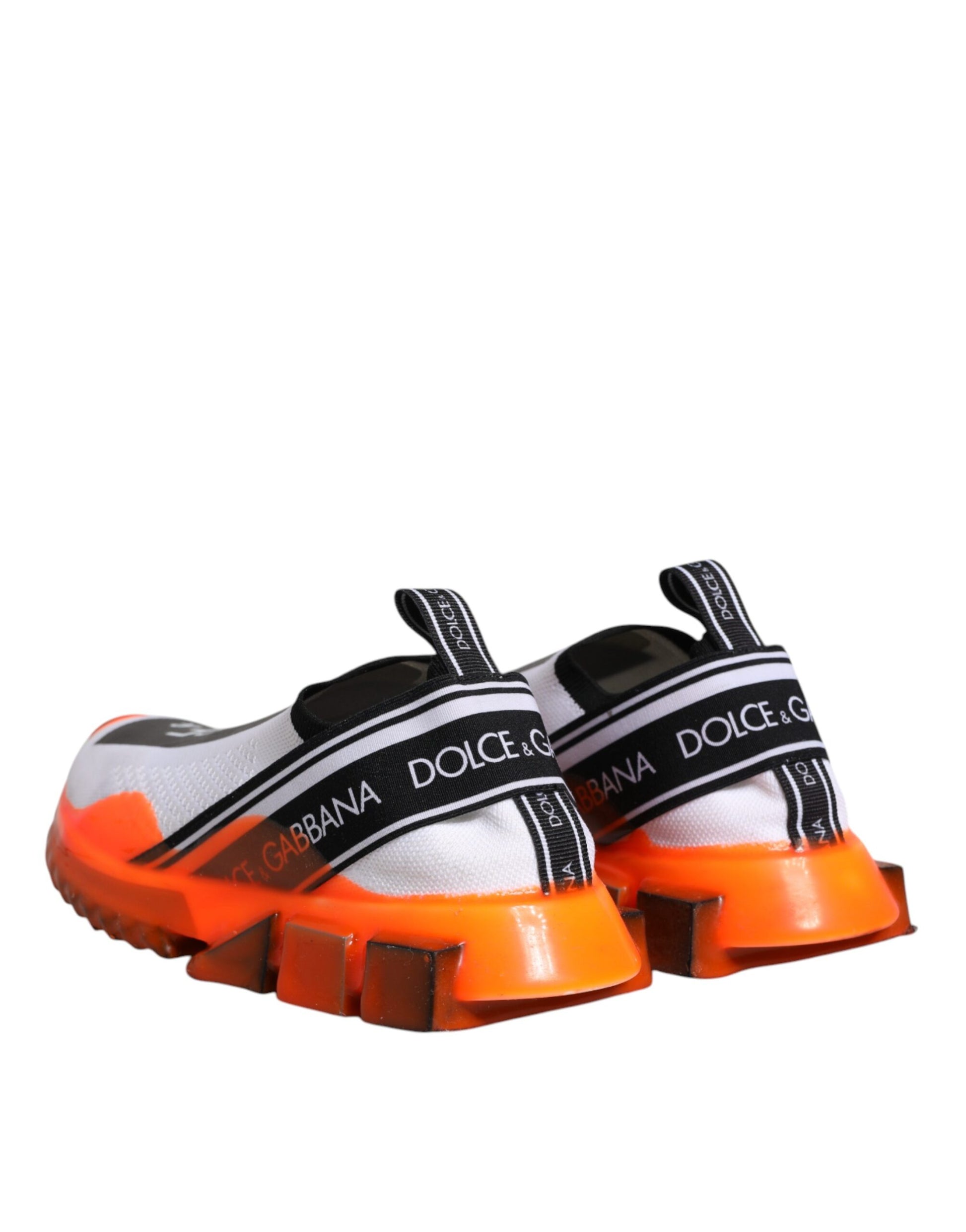 White and orange slip-on shoes with black straps featuring the Dolce & Gabbana logo