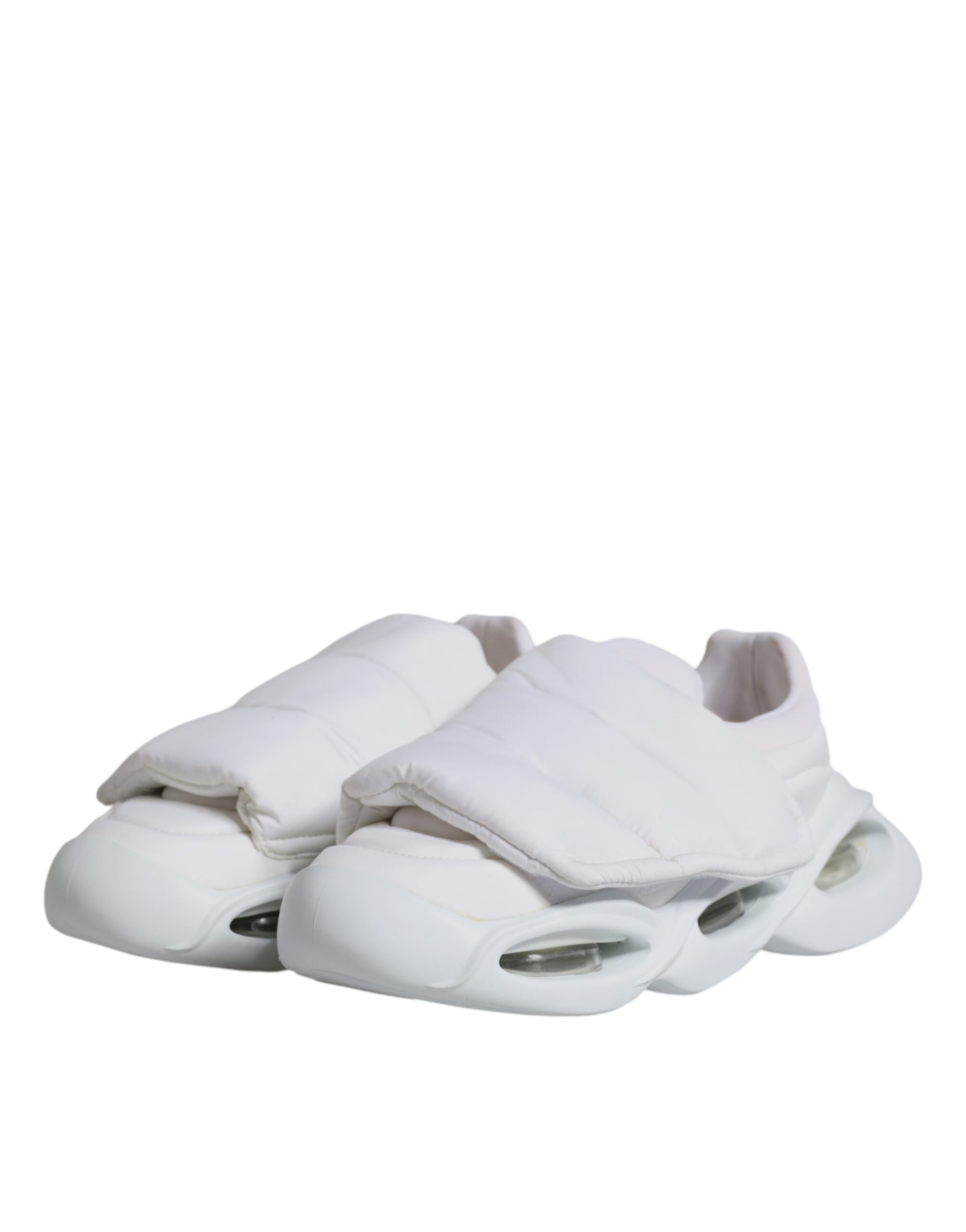 A pair of white padded fabric low top sneakers with a lace-up front