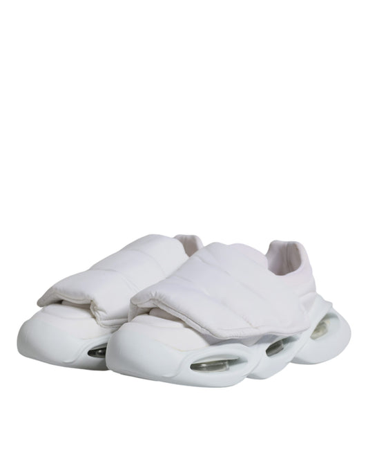 A pair of white padded fabric low top sneakers with a lace-up front