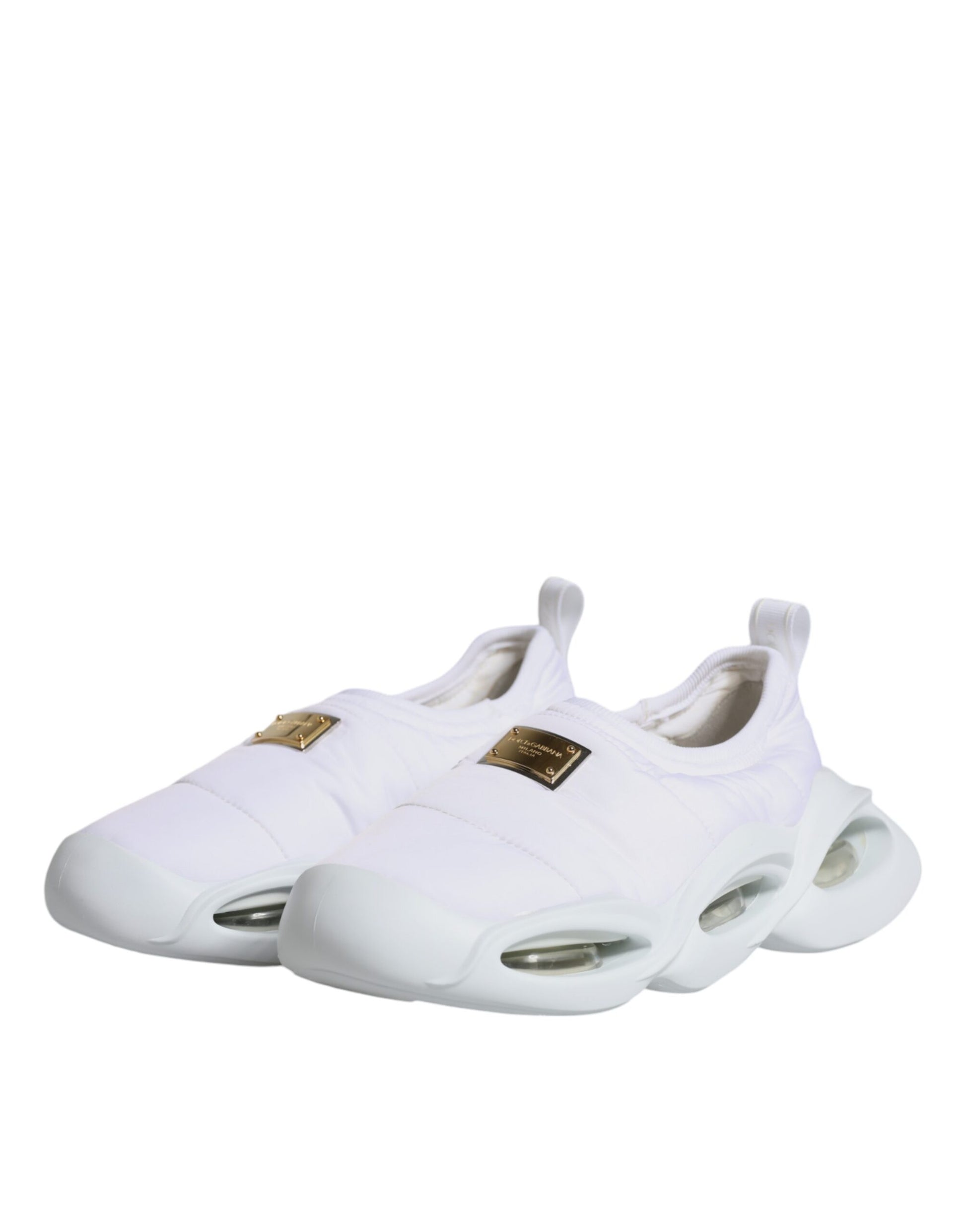 White sneakers with gold accents and a black logo on the side