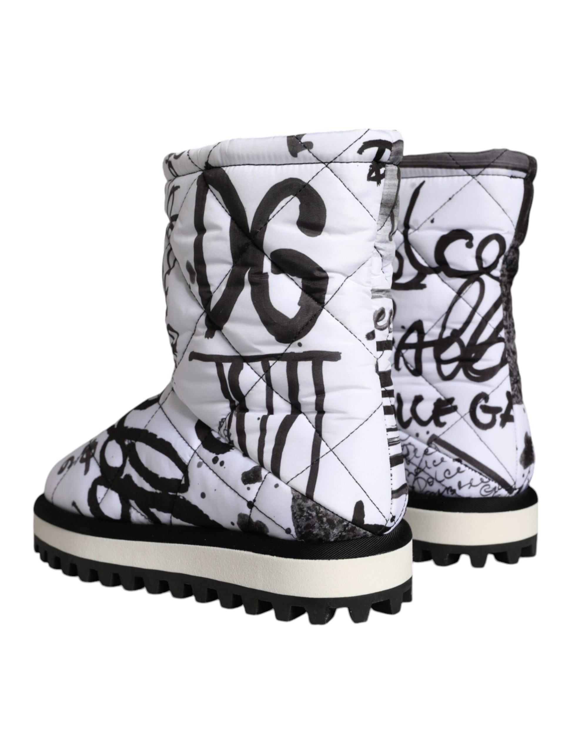 Pair of white boots with black writing