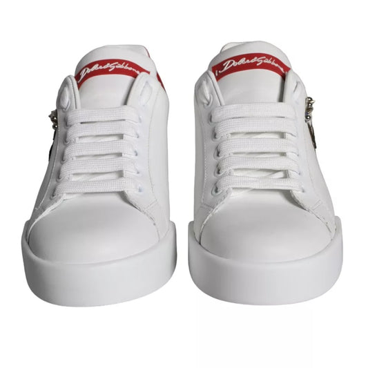 Pair of white sneakers with red accents and laces