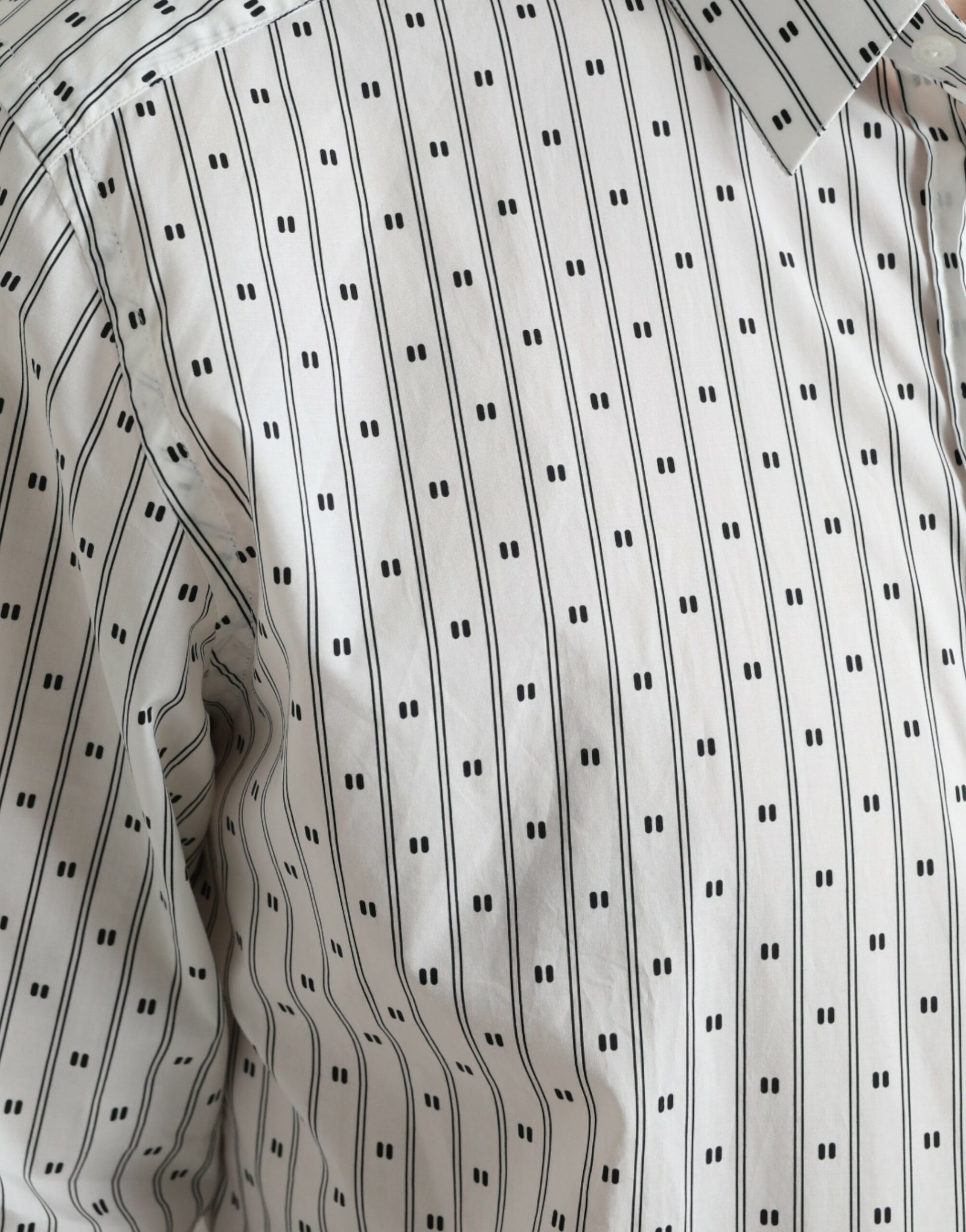 The shirt has a pattern of black lines on a white background