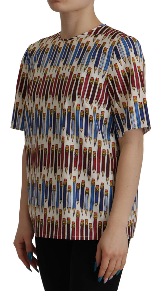 The shirt is colorful with a pattern of pencils on it