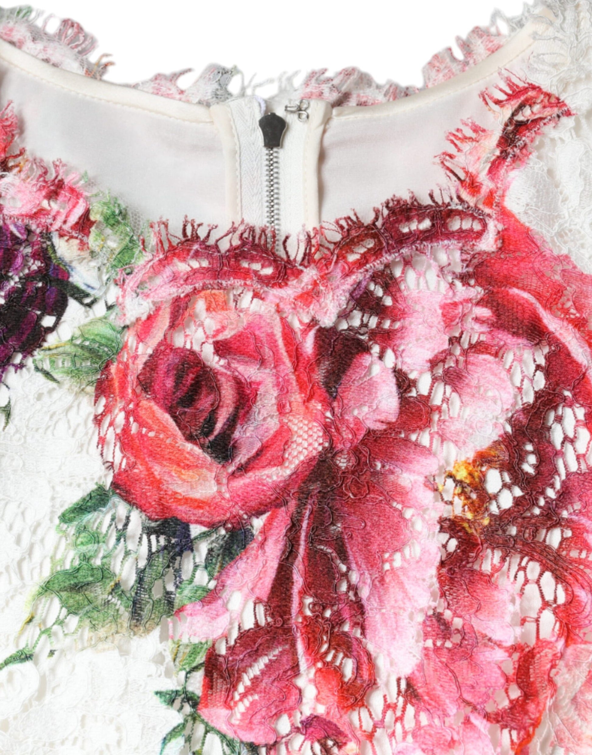 Floral embroidered garment with pink roses on a white background