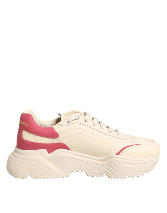 A pair of white pink leather sneakers with red accents, featuring a chunky sole and laces