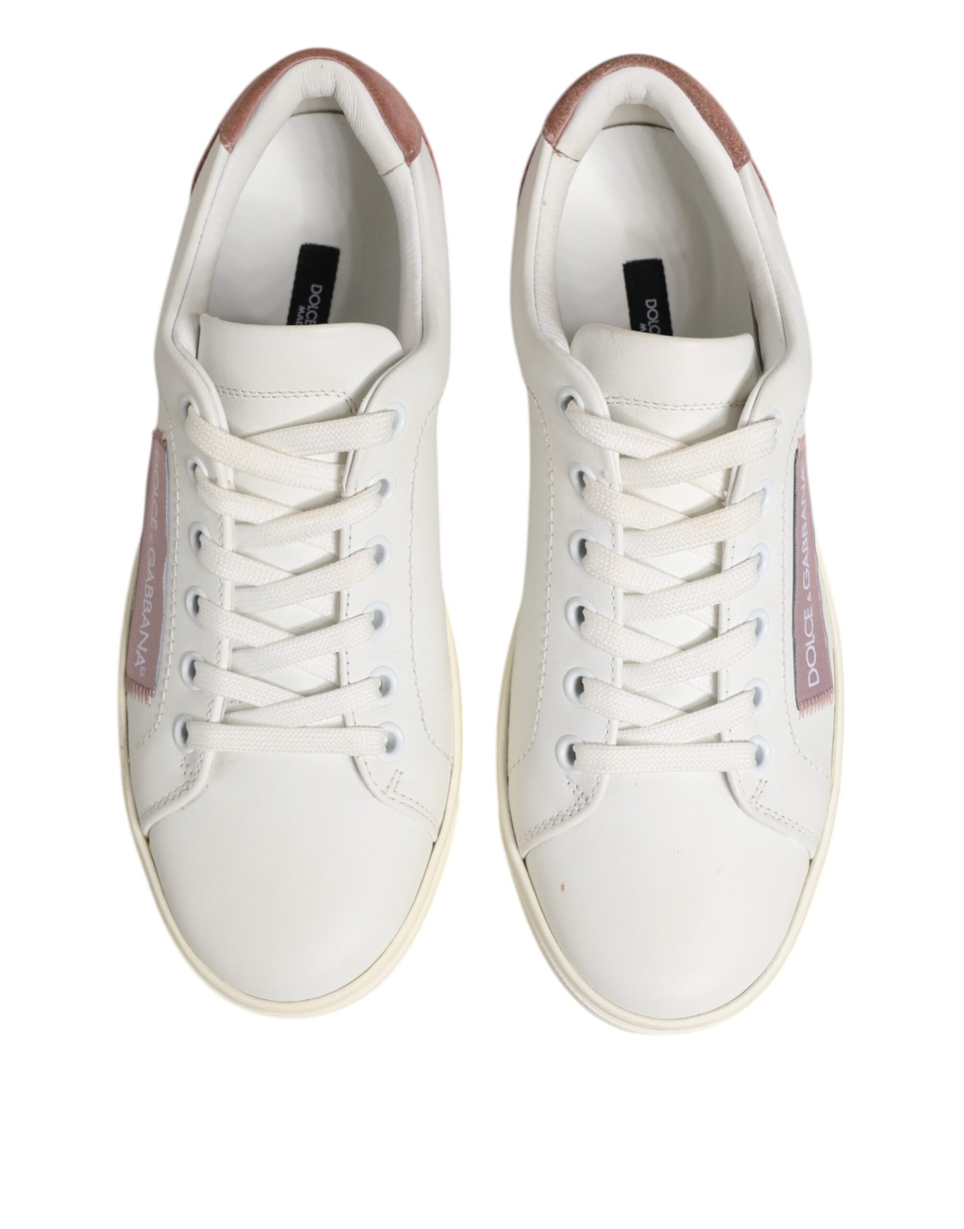 Pair of white sneakers with pink accents