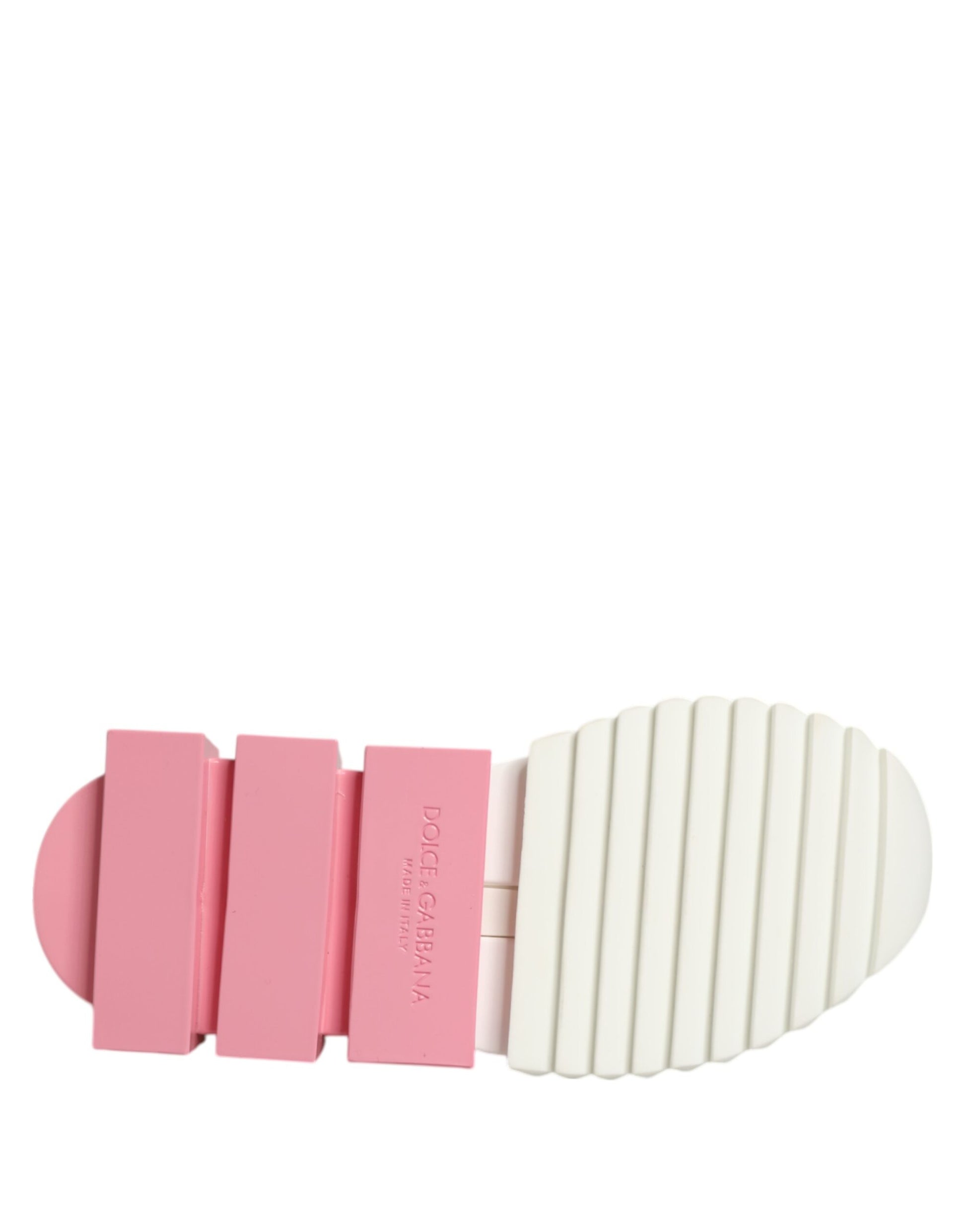 A pair of white pink low top sneakers with a textured sole