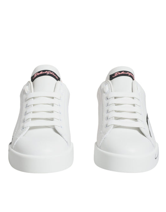 Pair of white sneakers with pink laces and a black logo on the side