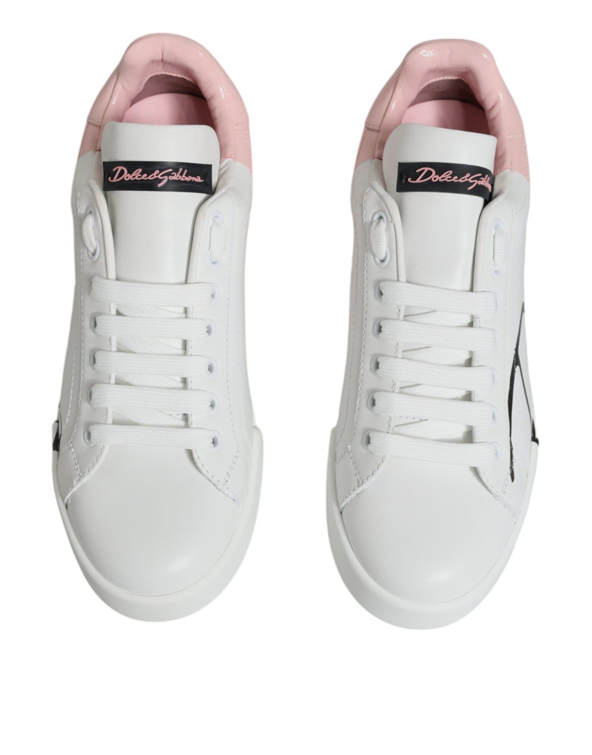 Pair of white sneakers with pink accents and laces