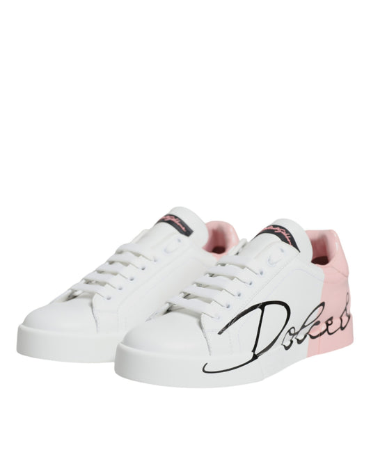 Pair of white sneakers with pink accents and black laces