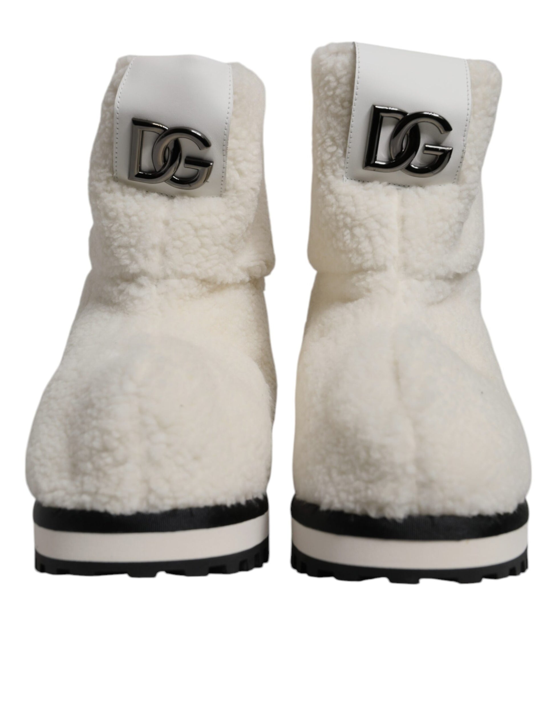 Pair of white fur lined boots with black soles