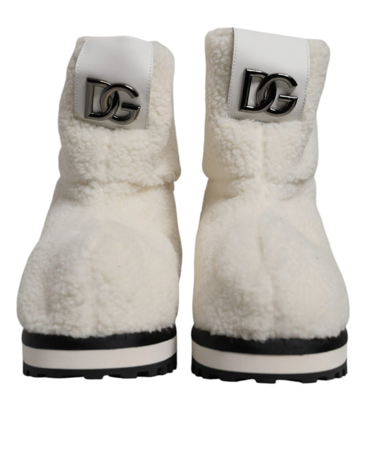 Pair of white fur lined boots with black soles