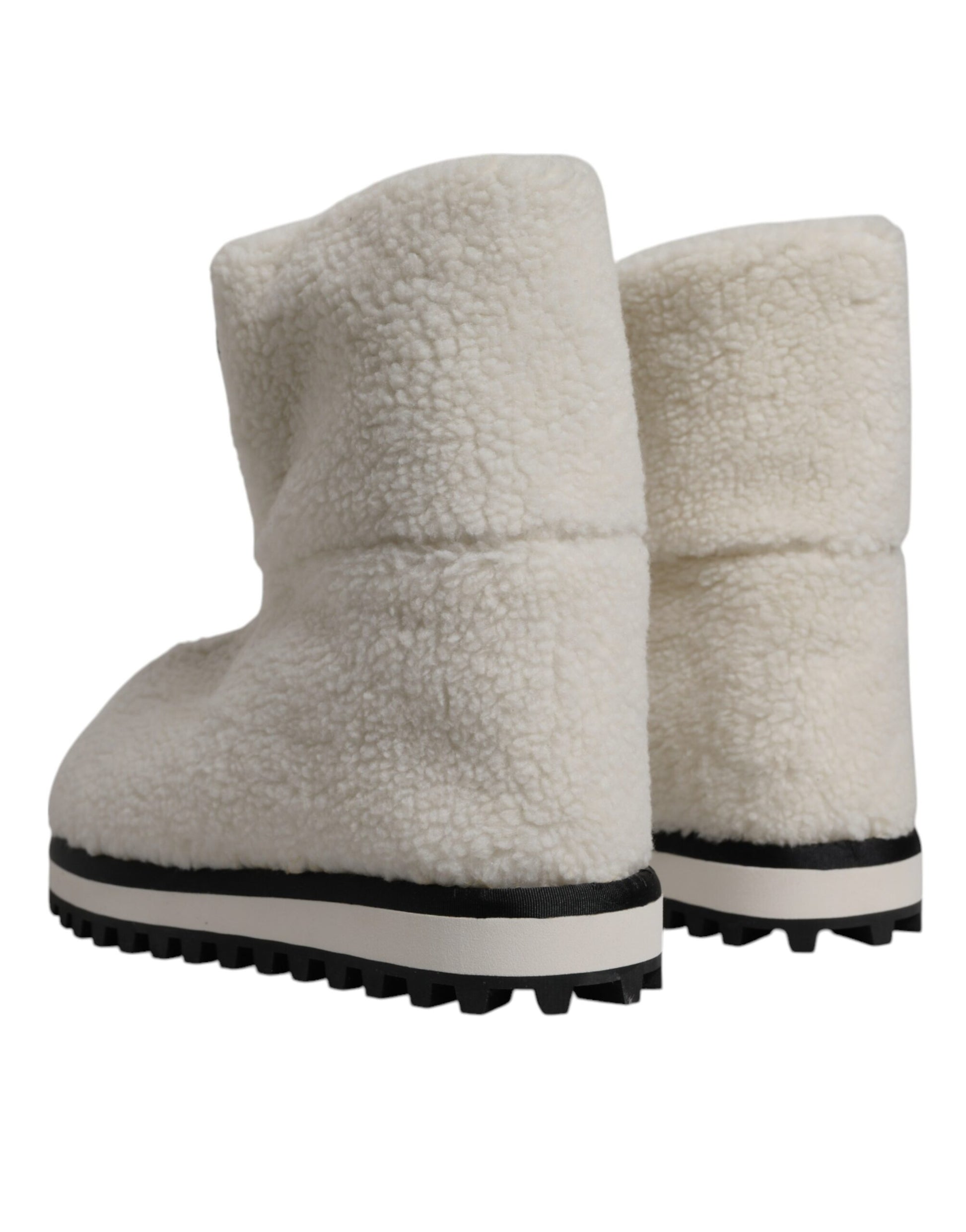Pair of tan suede boots with black trim