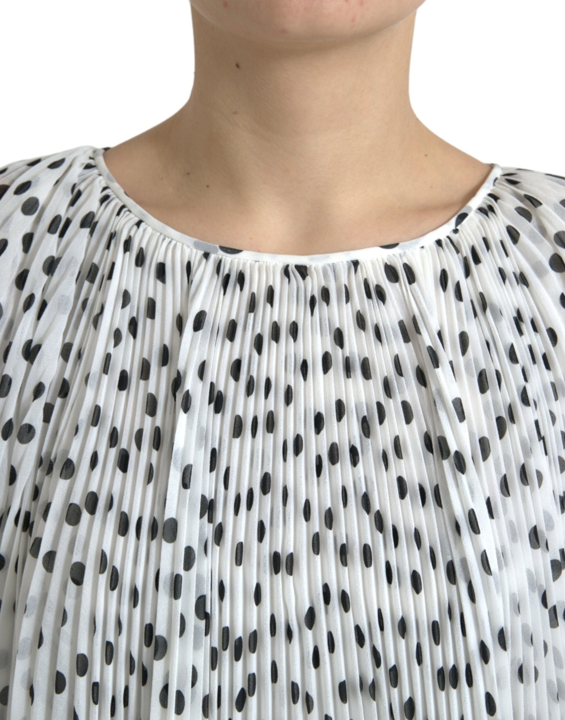White polka dot dress with pleats and A-line silhouette