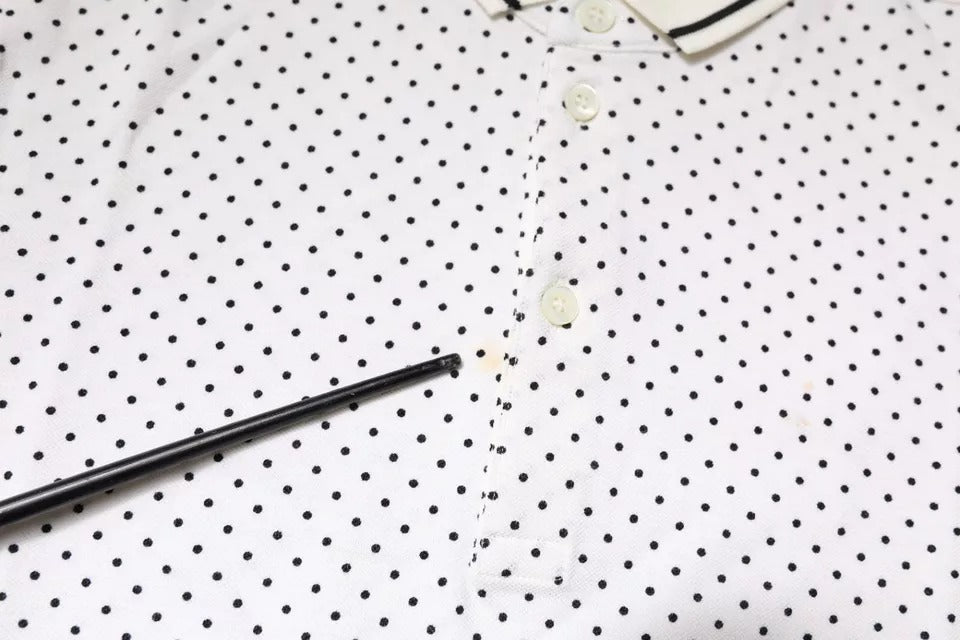 Black pen on white paper with black dots