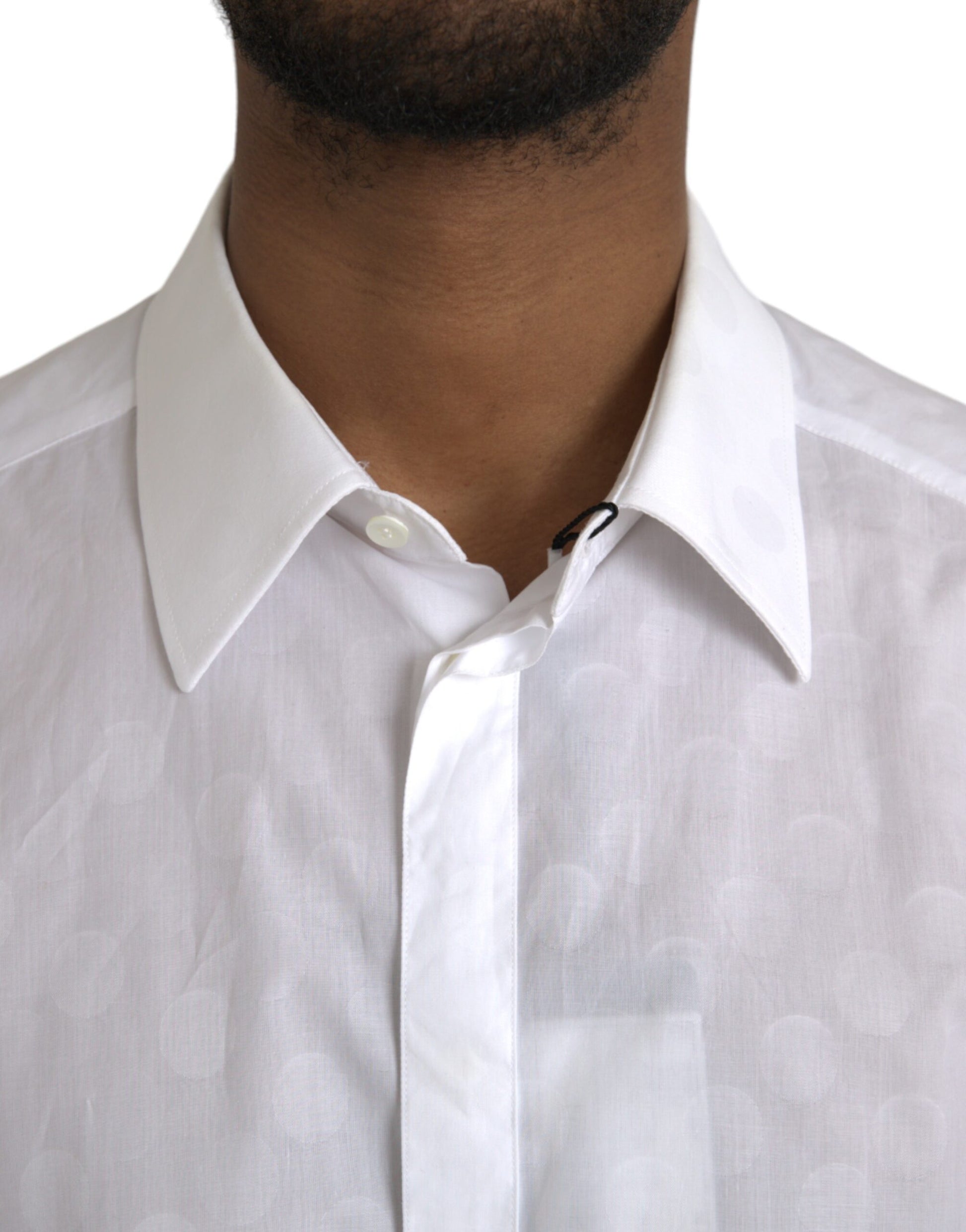 A white polka dotted cotton dress shirt with a gold collar and cuffs