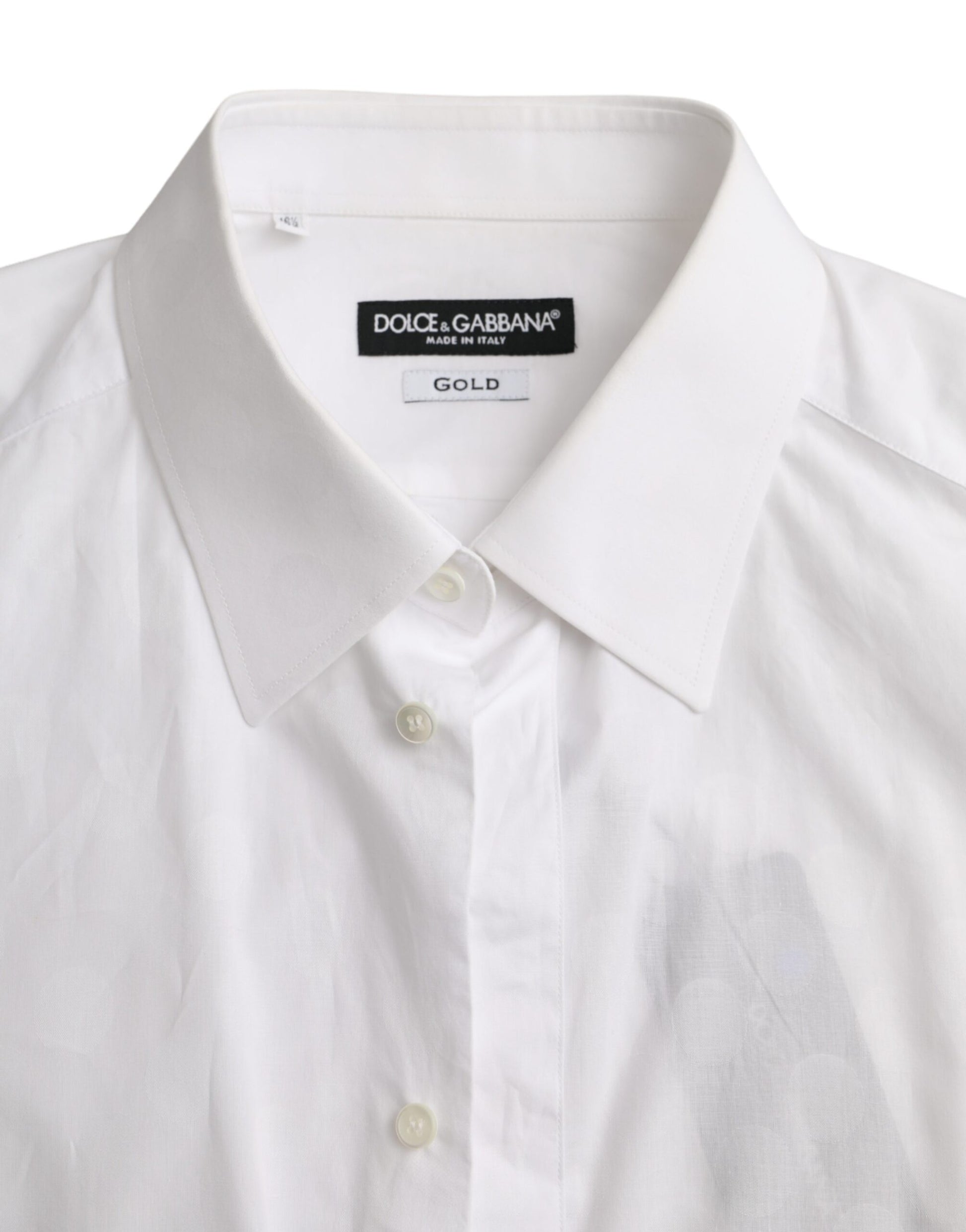A white polka dotted cotton dress shirt with a gold label on the collar