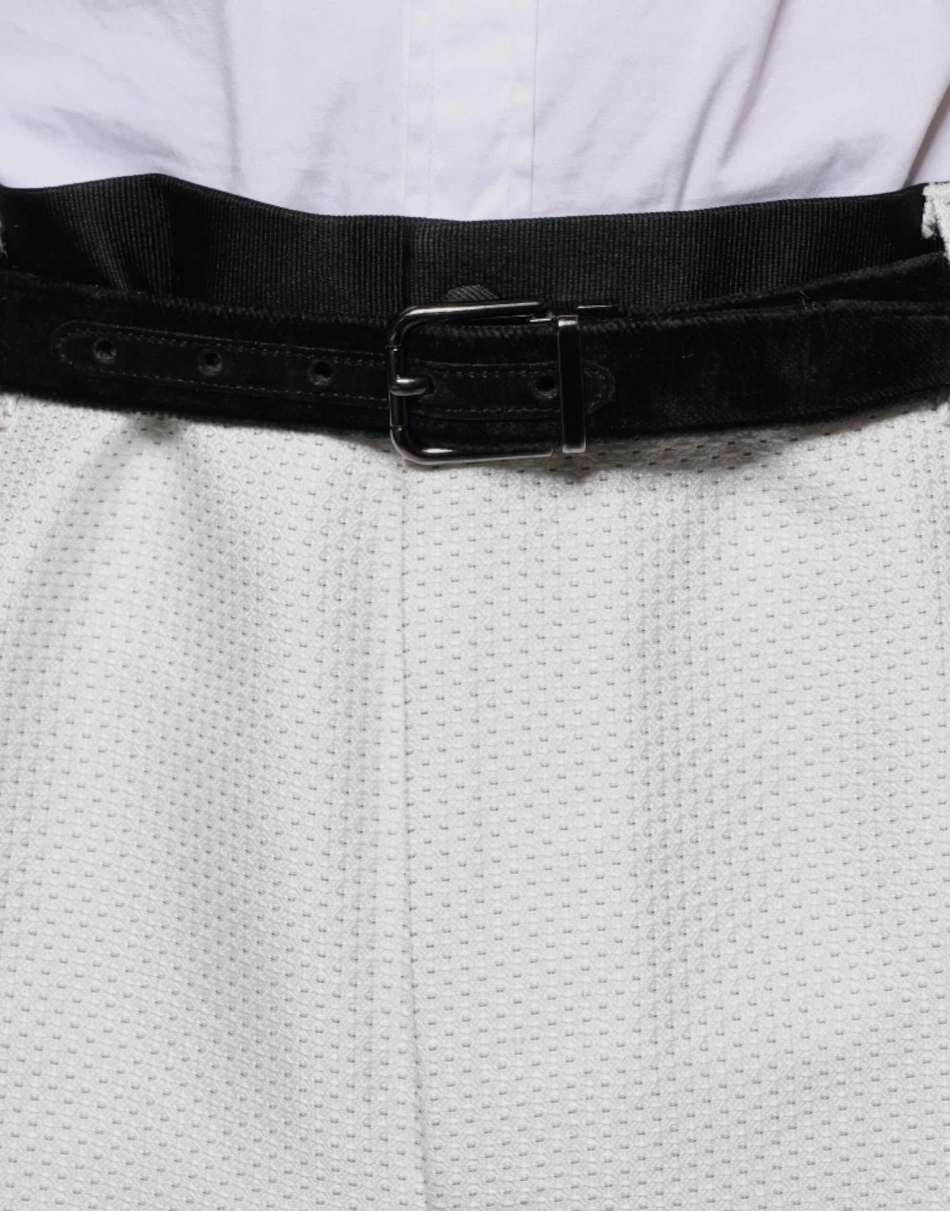 A pair of white polyester formal dress pants with a black belt and buckle