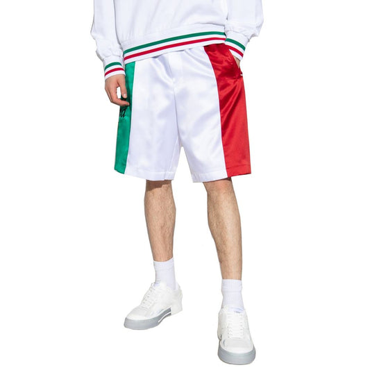 Man wearing white sneakers and red, white, green shorts