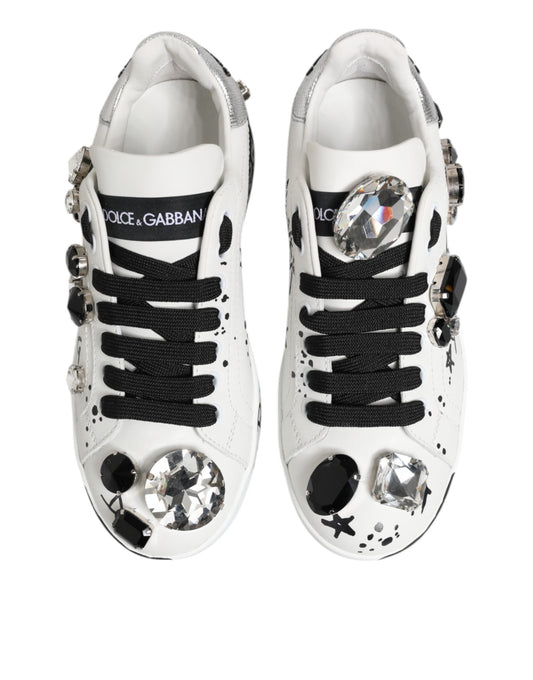 Pair of white sneakers with black laces, embellished with crystals and studs
