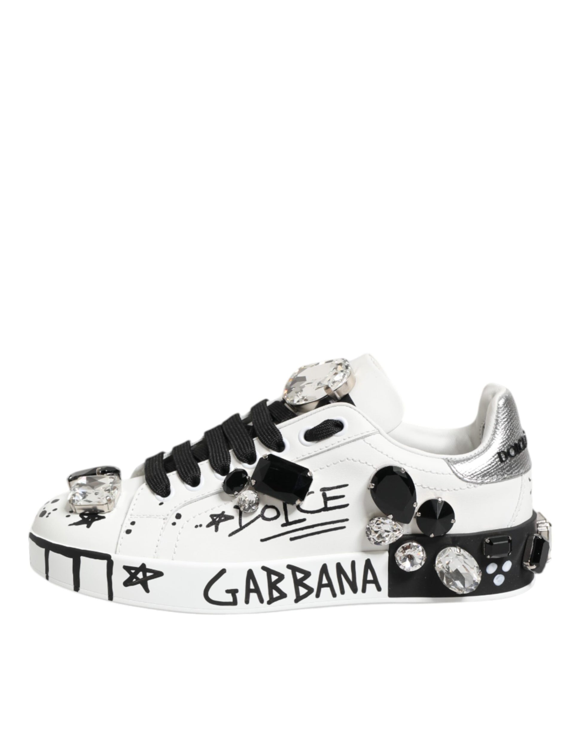 White sneakers with crystals, black laces and text on side reading "Dolce & Gabbana"