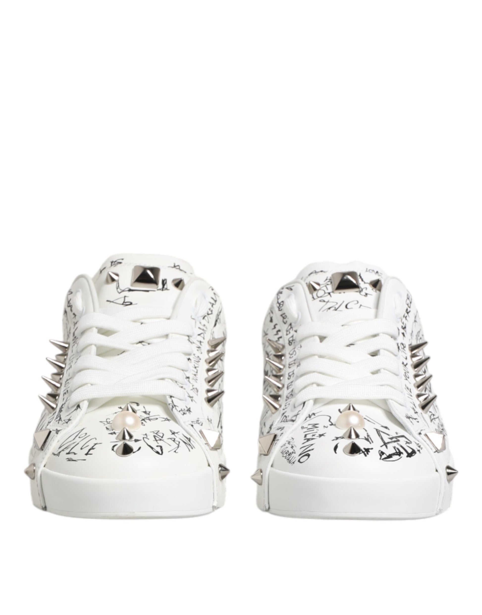 Pair of white sneakers with studs, featuring a design on the side and toe cap