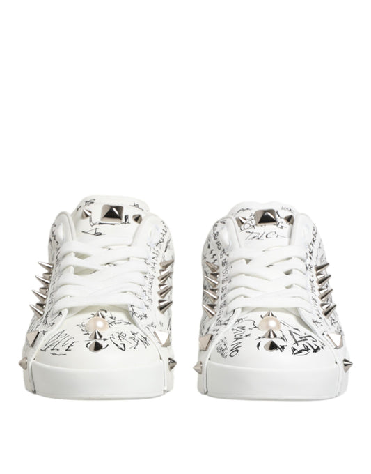 Pair of white sneakers with studs, featuring a design on the side and toe cap