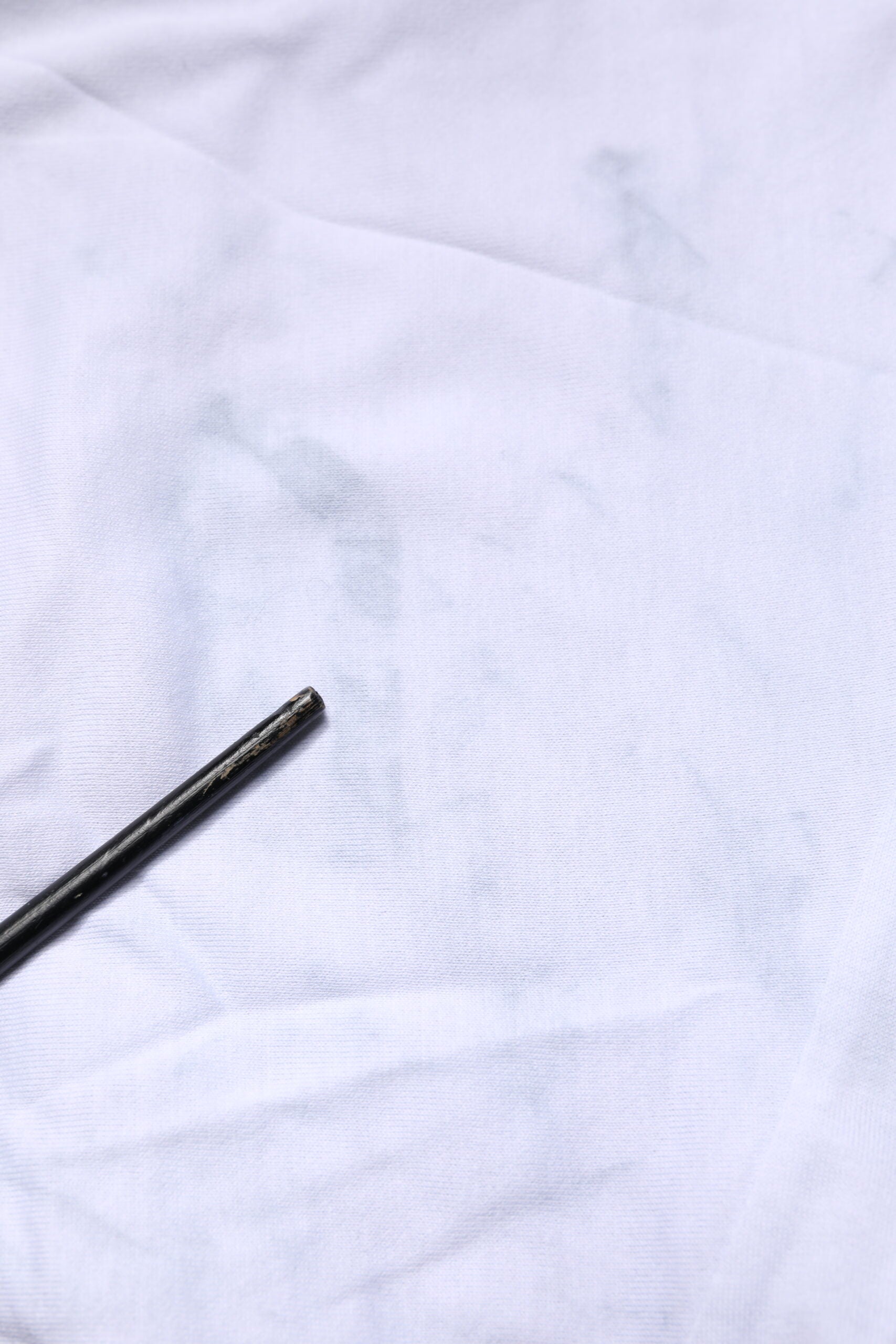 White cloth with a black mark on it