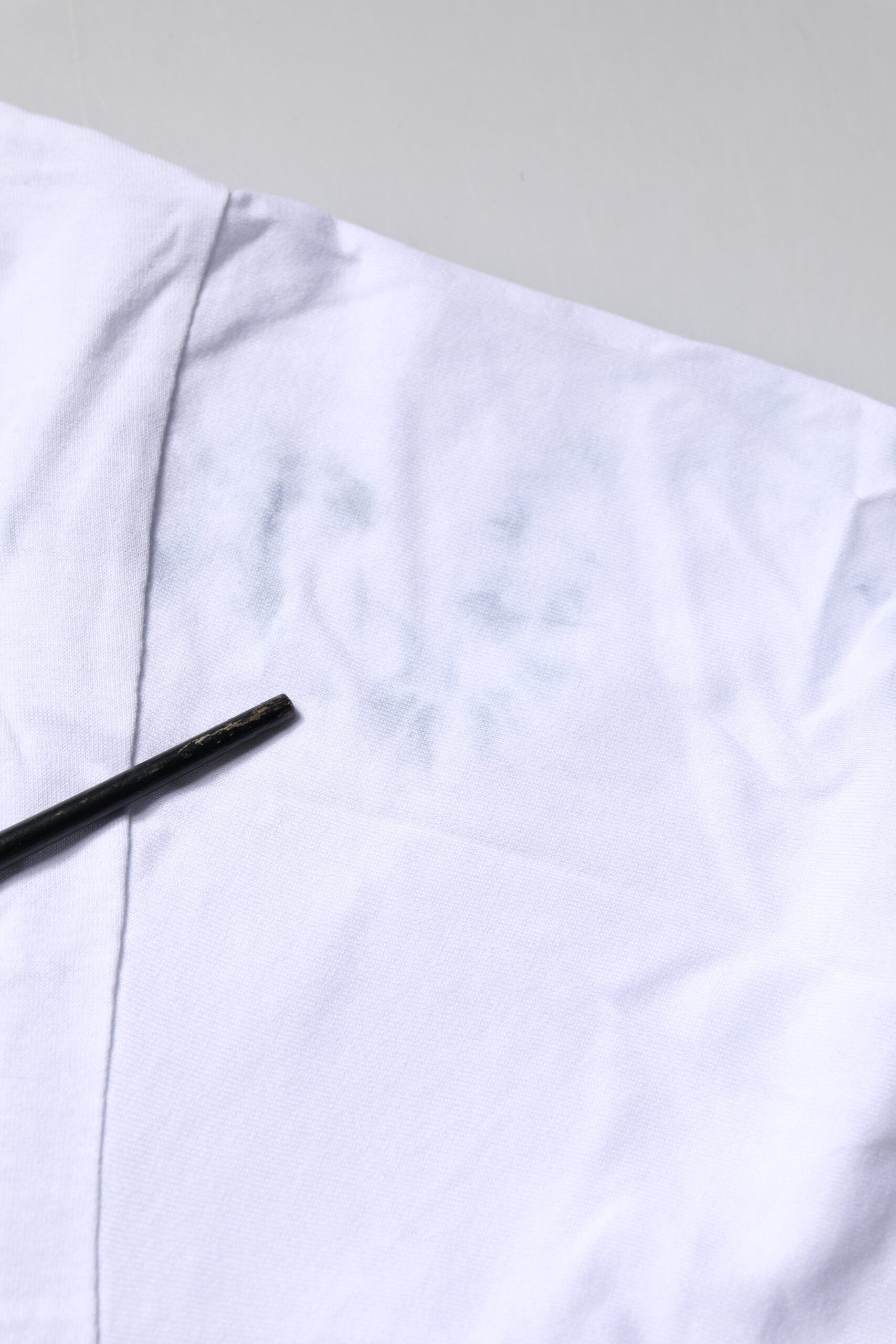White shirt with stain on front