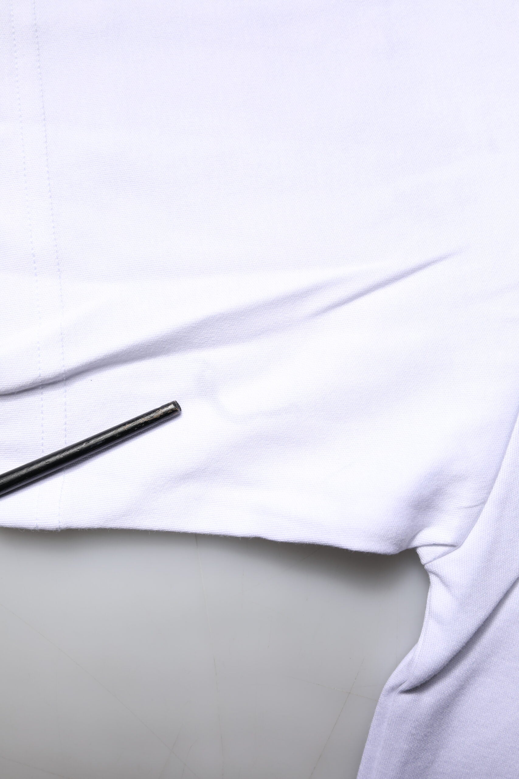White t-shirt with black pen in pocket