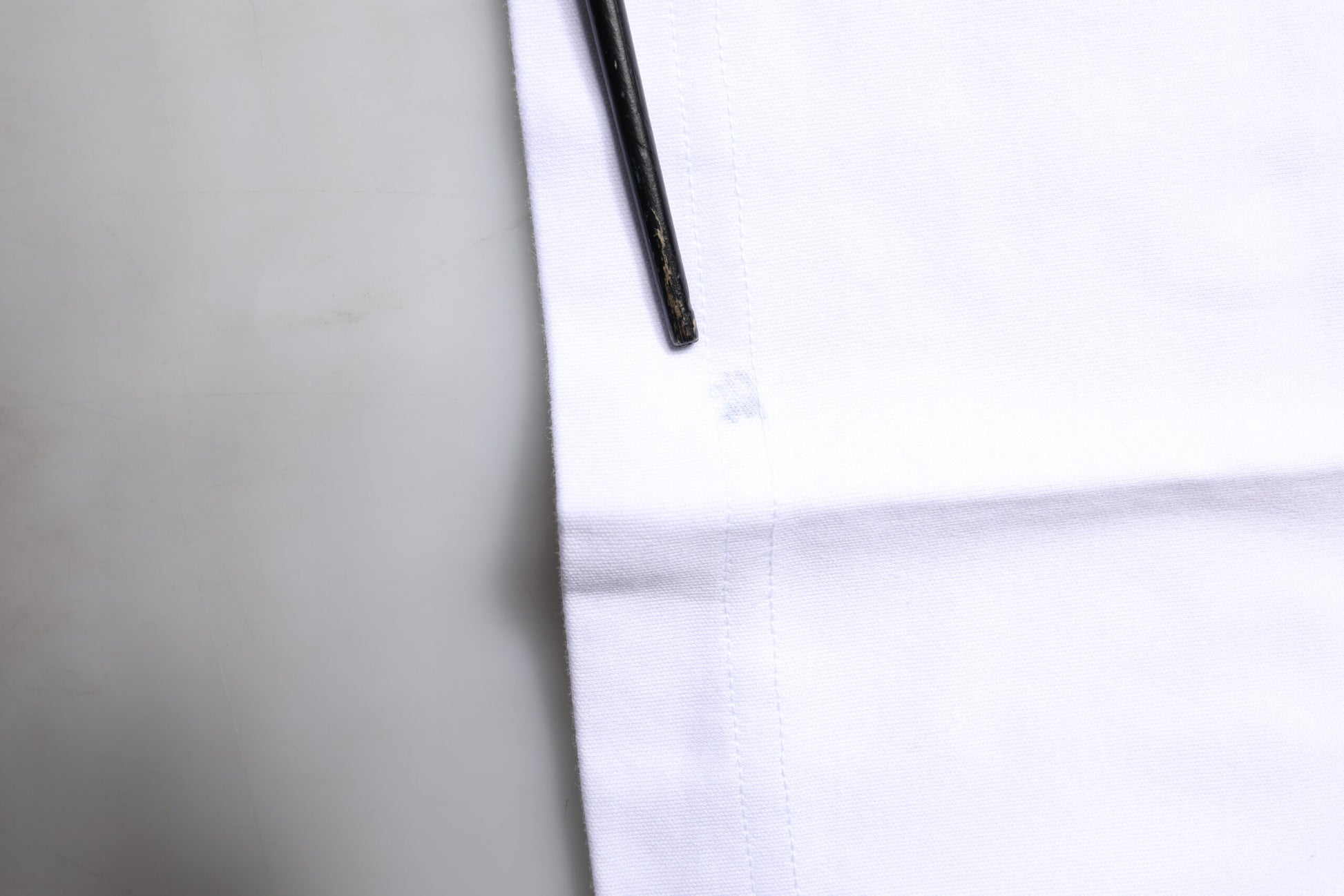 White towel with black marking pen on top