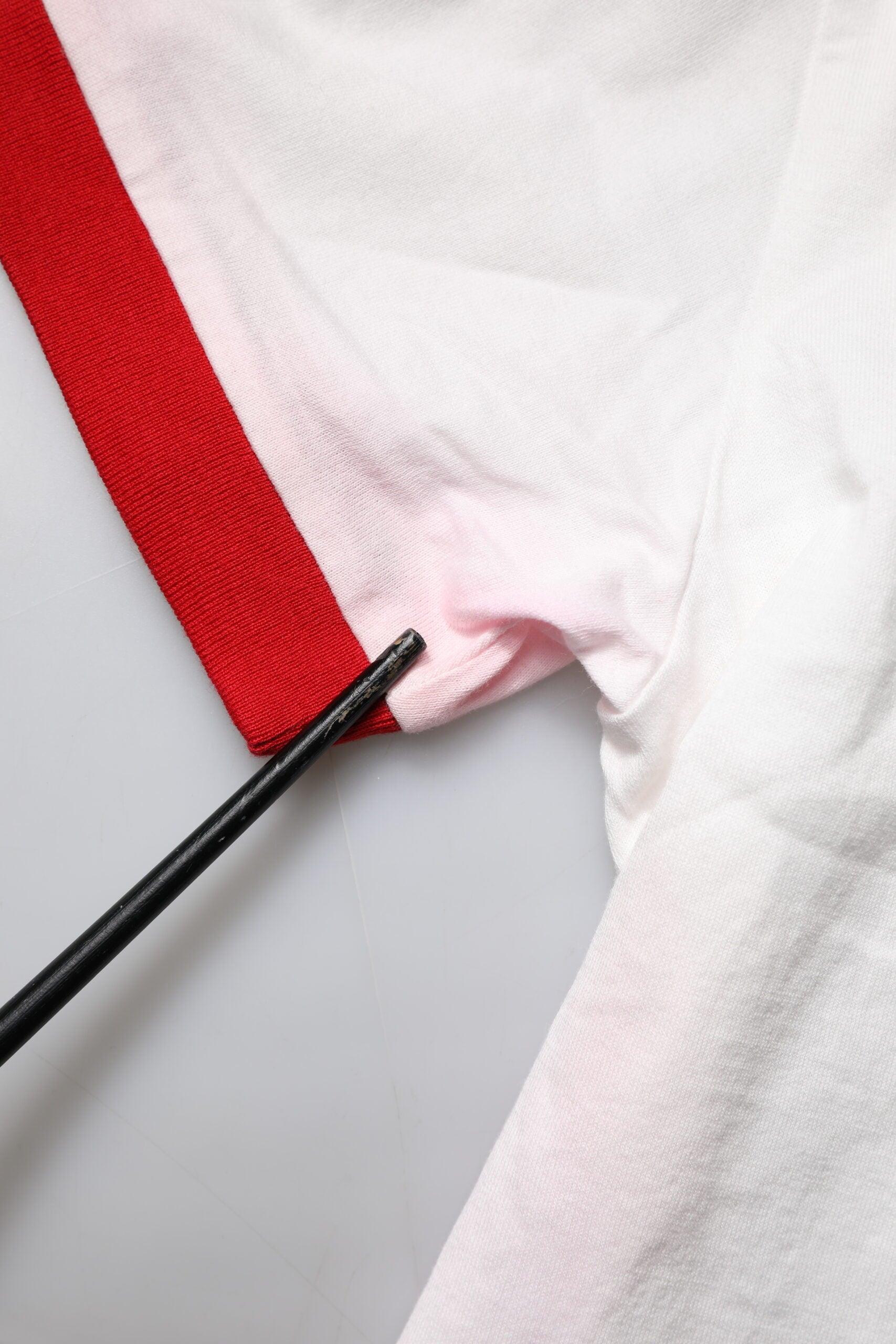 White shirt with red stripe on sleeve