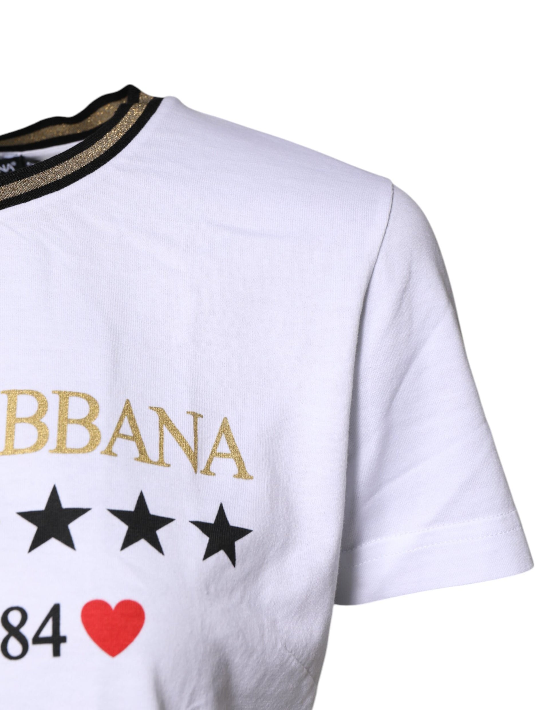White t-shirt with gold lettering and stars