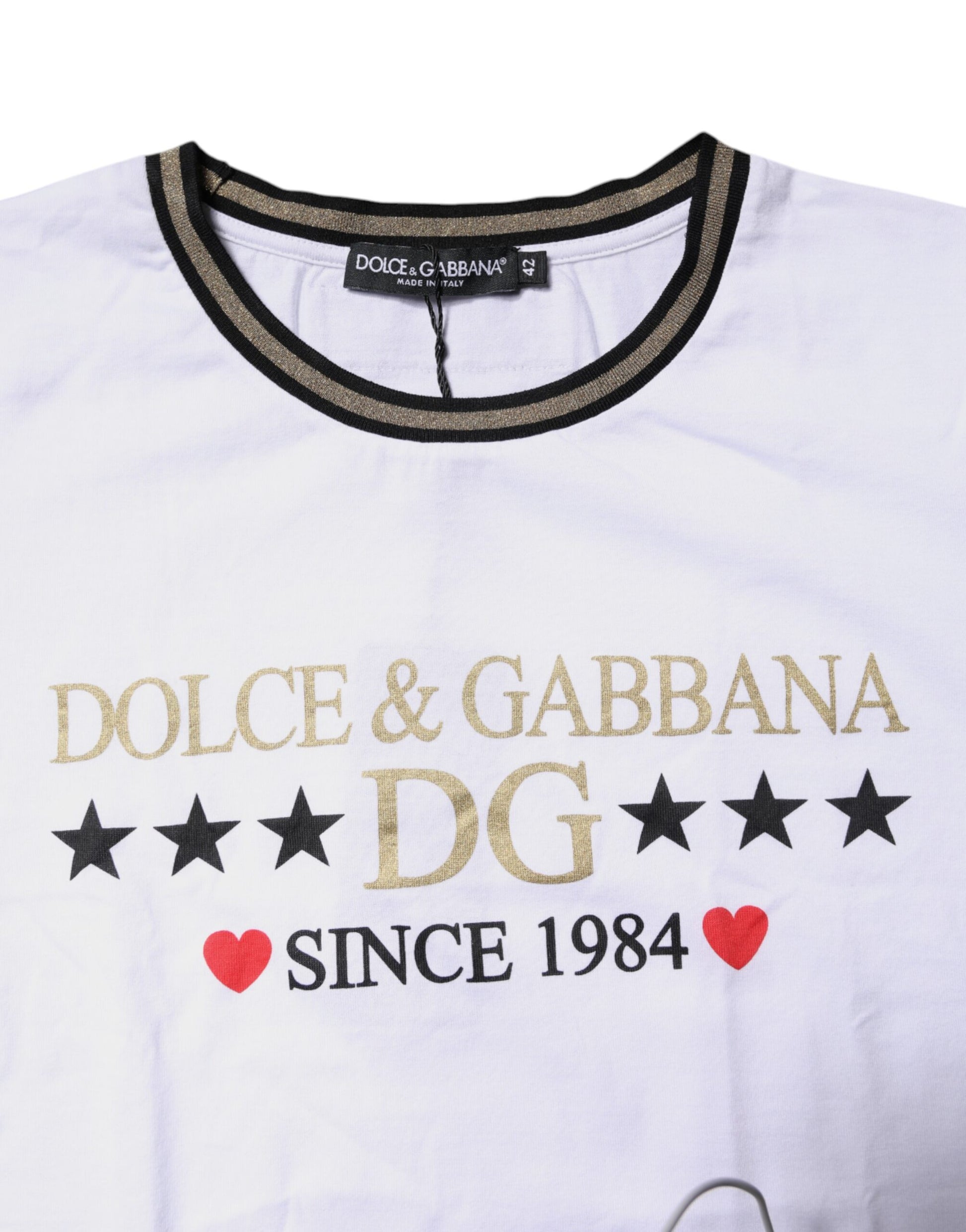 White t-shirt with gold lettering featuring brand names Dolce & Gabbana since 1984
