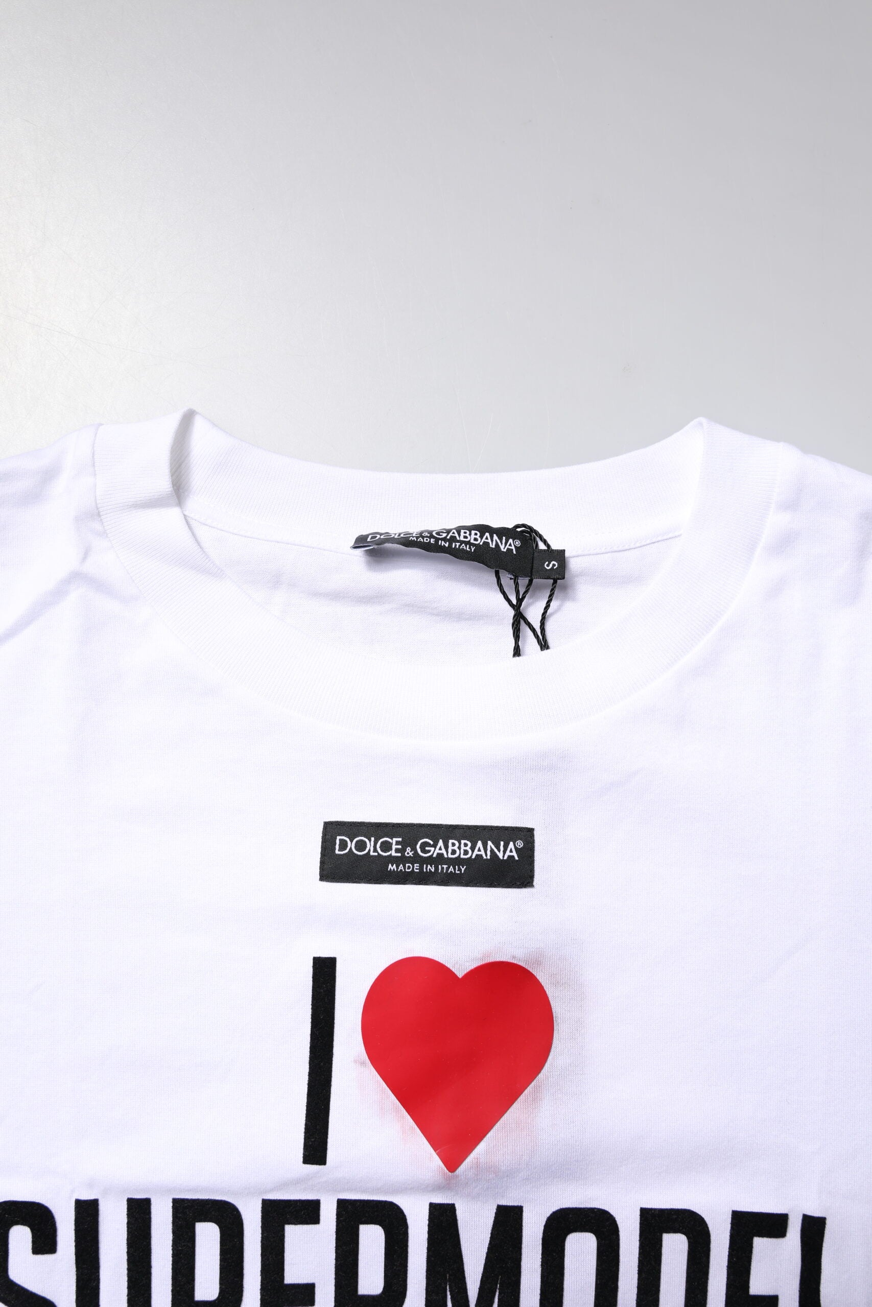 White t-shirt with red heart graphic on front