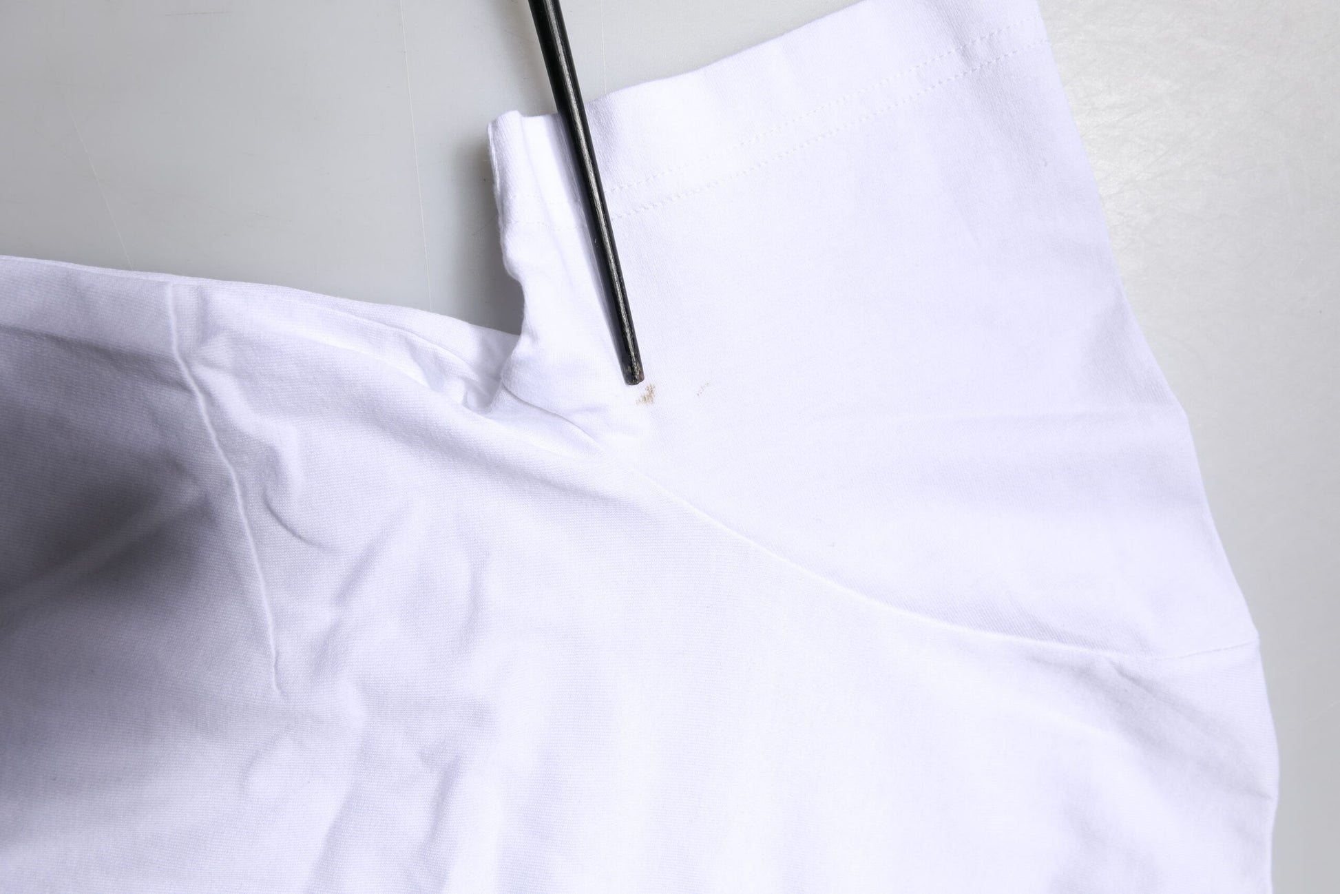 White cloth with a black stitching needle
