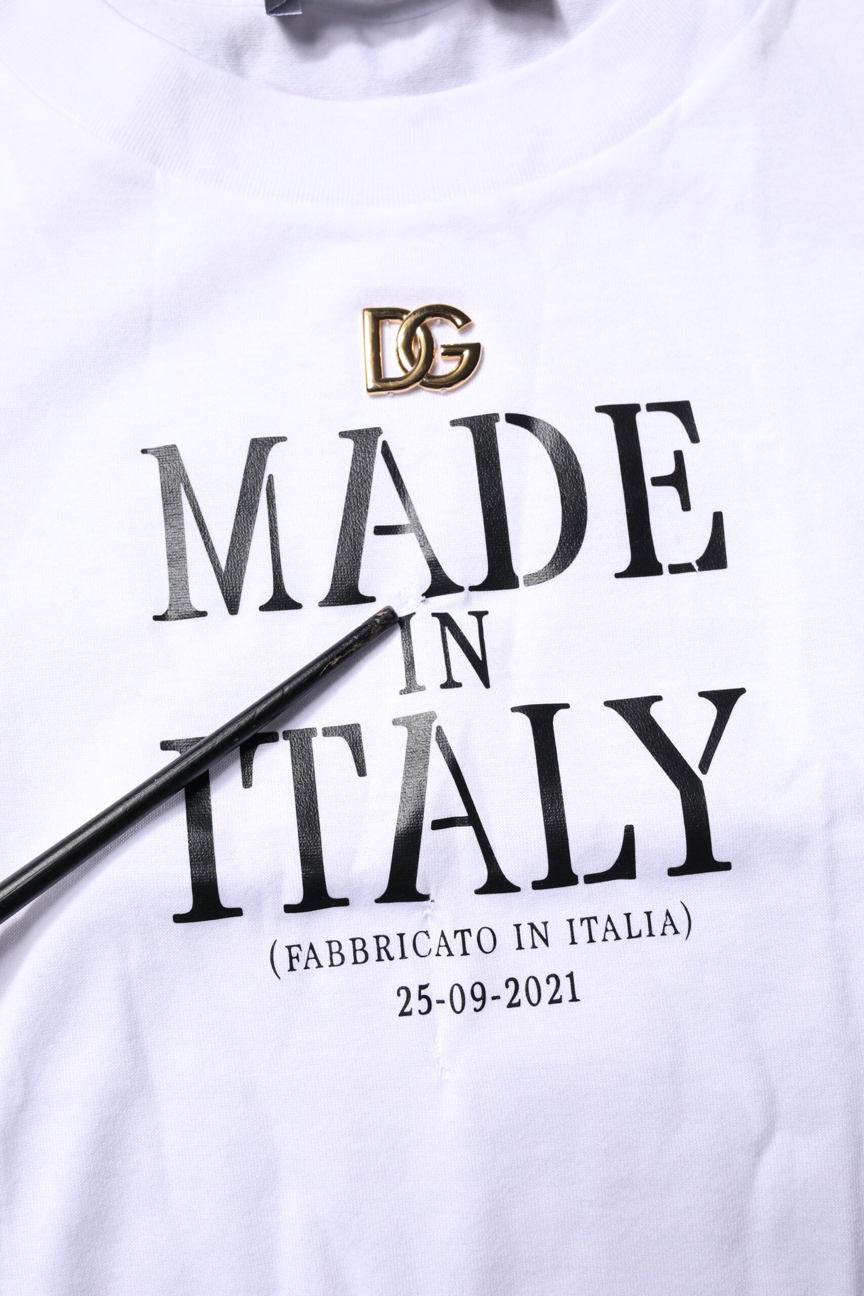 White t-shirt with black lettering and logo