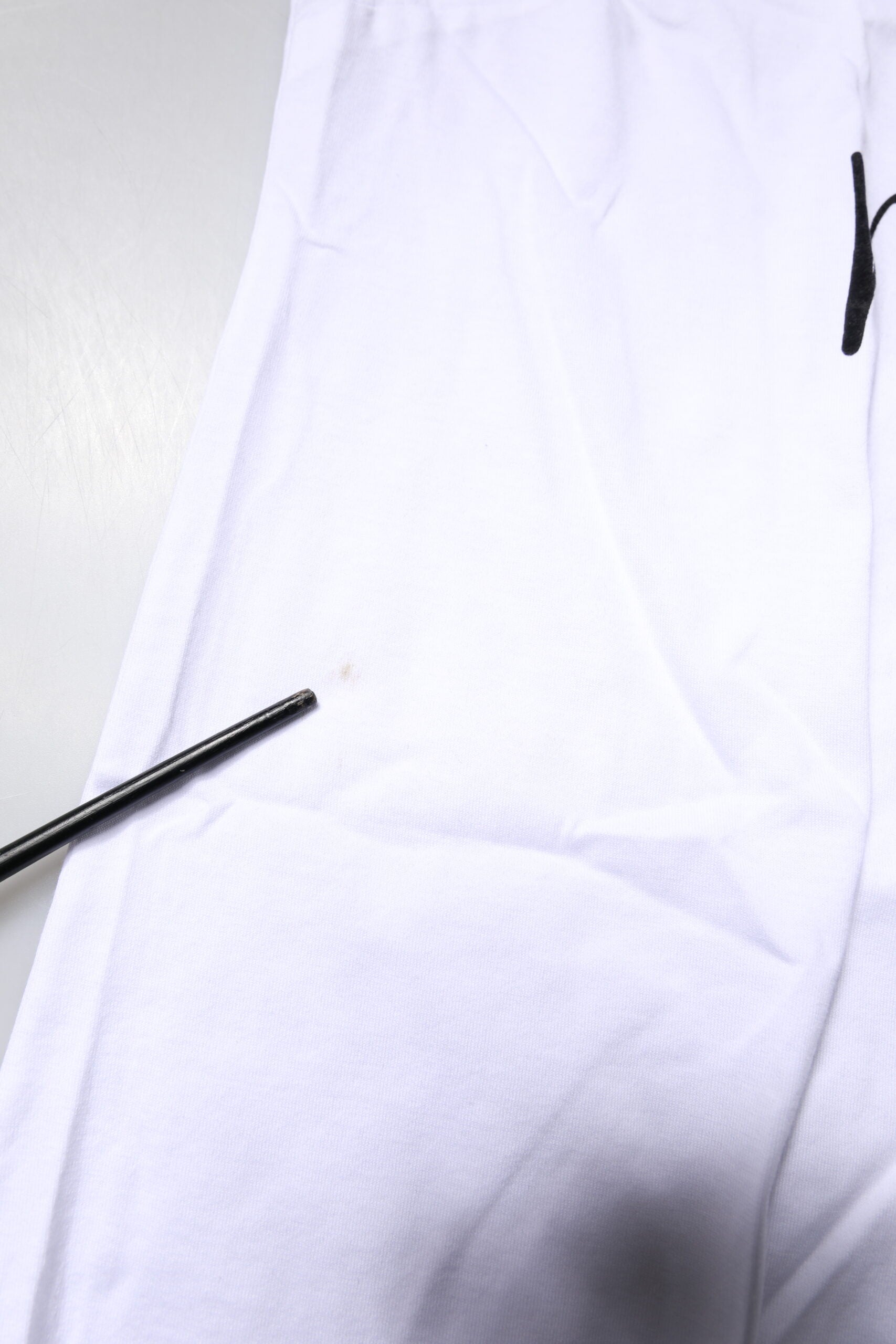 White shirt with black markings on it